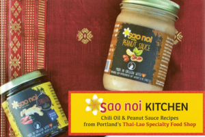 Cookbook cover with two jars of chili oil and peanut sauce.